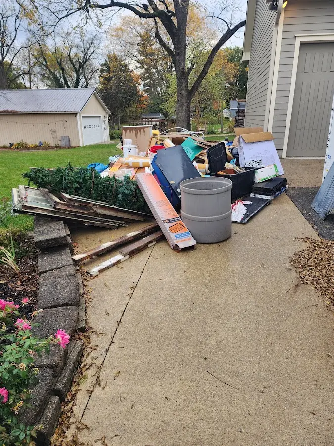 Dumpster being loaded with debris for Commercial Dumpster Rental in Granbury